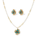 14K gold-plated floral jewelry set with blue cubic zirconia centers and pearl chain details on white background.