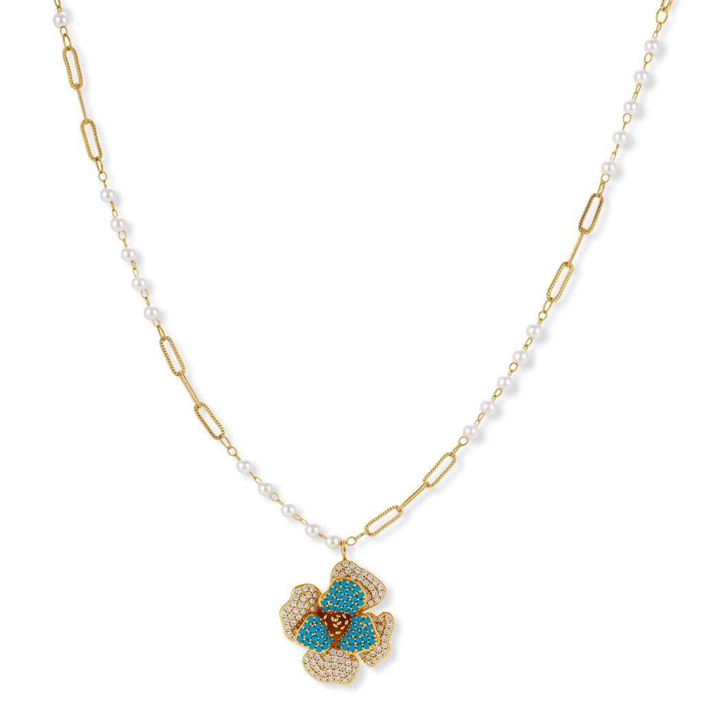 14K gold-plated floral jewelry set with blue cubic zirconia centers and pearl chain details on white background.