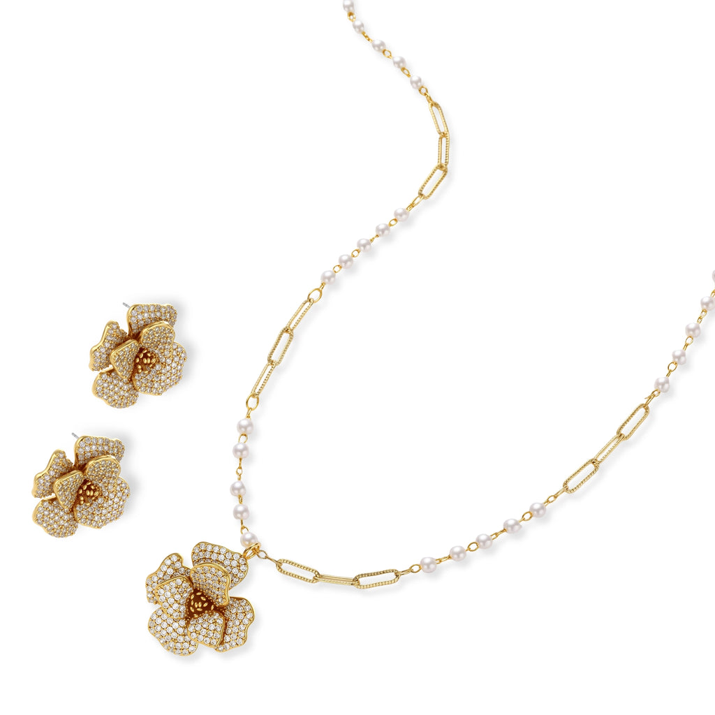 14K gold-plated floral jewelry set with blue cubic zirconia centers and pearl chain details on white background.