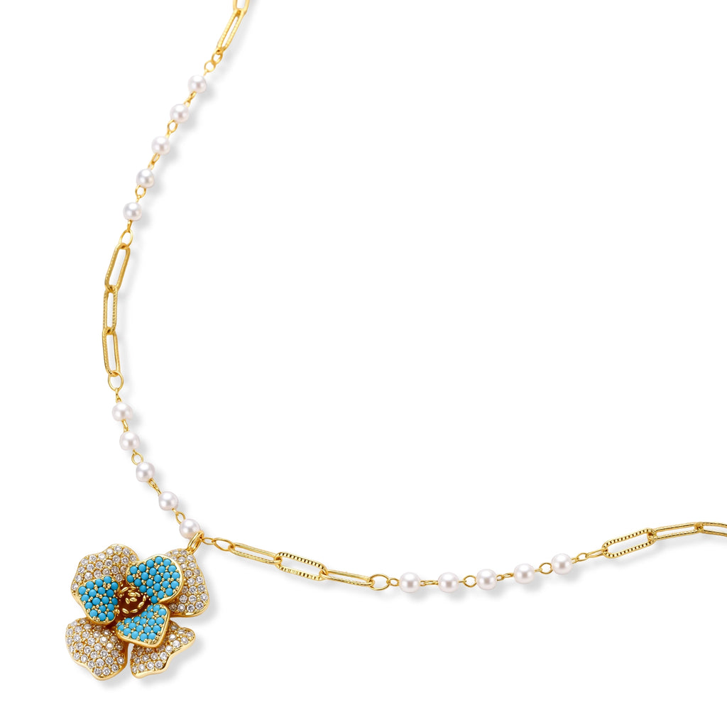 14K gold-plated floral jewelry set with blue cubic zirconia centers and pearl chain details on white background.